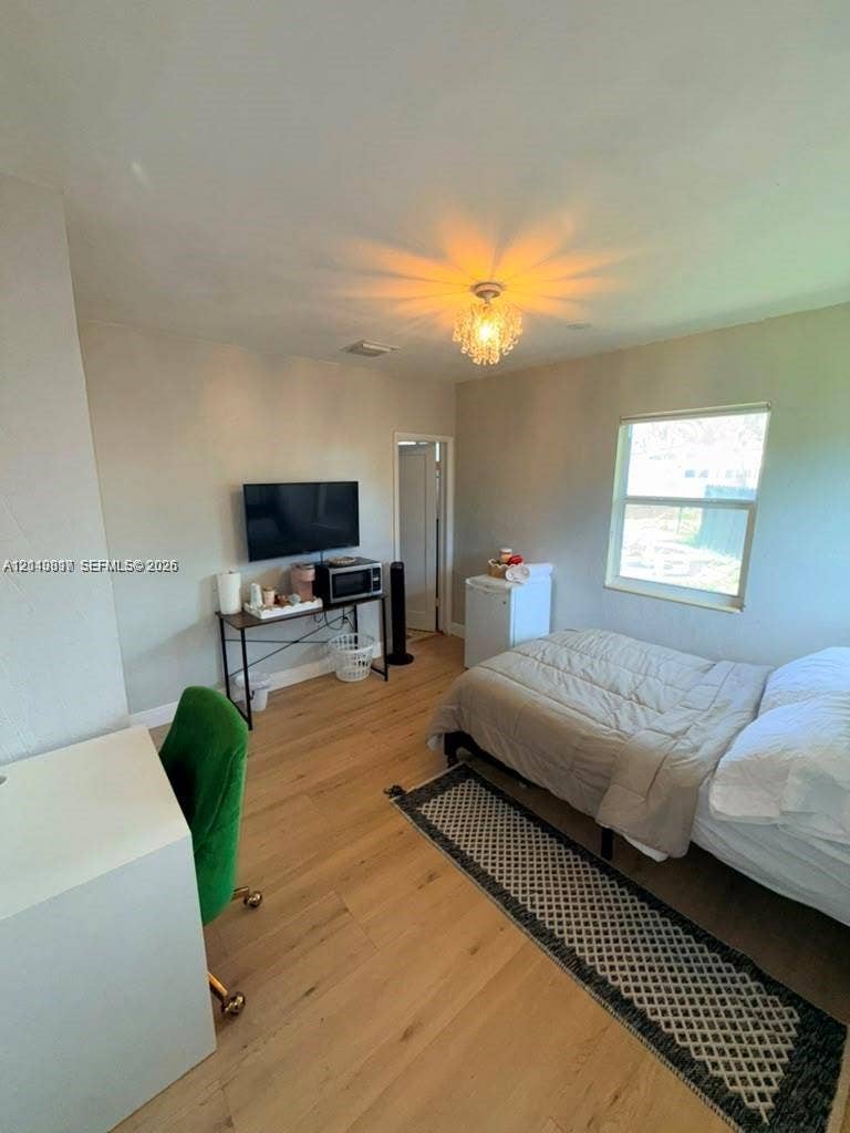 201 Flagler Drive, #201, Miami Springs, Miami Springs, FL 33166 Wood-finish flooring, recessed lighting, crystal-style flush mount fixture, and a large window