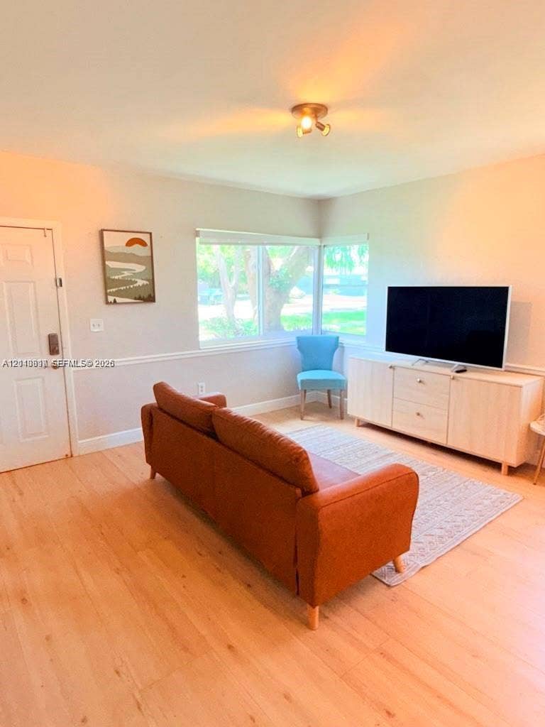 201 Flagler Drive, #201, Miami Springs, Miami Springs, FL 33166 Wood-finish flooring, light-colored walls, horizontal-pane windows, and neutral-toned chair rail molding