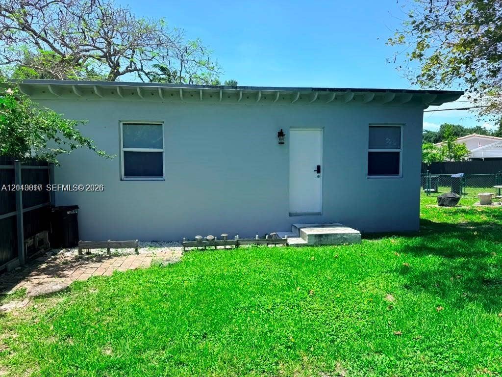 201 Flagler Drive, #201, Miami Springs, Miami Springs, FL 33166 Stucco exterior featuring exposed rafter tails, two windows with dark frames, and a concrete entry step