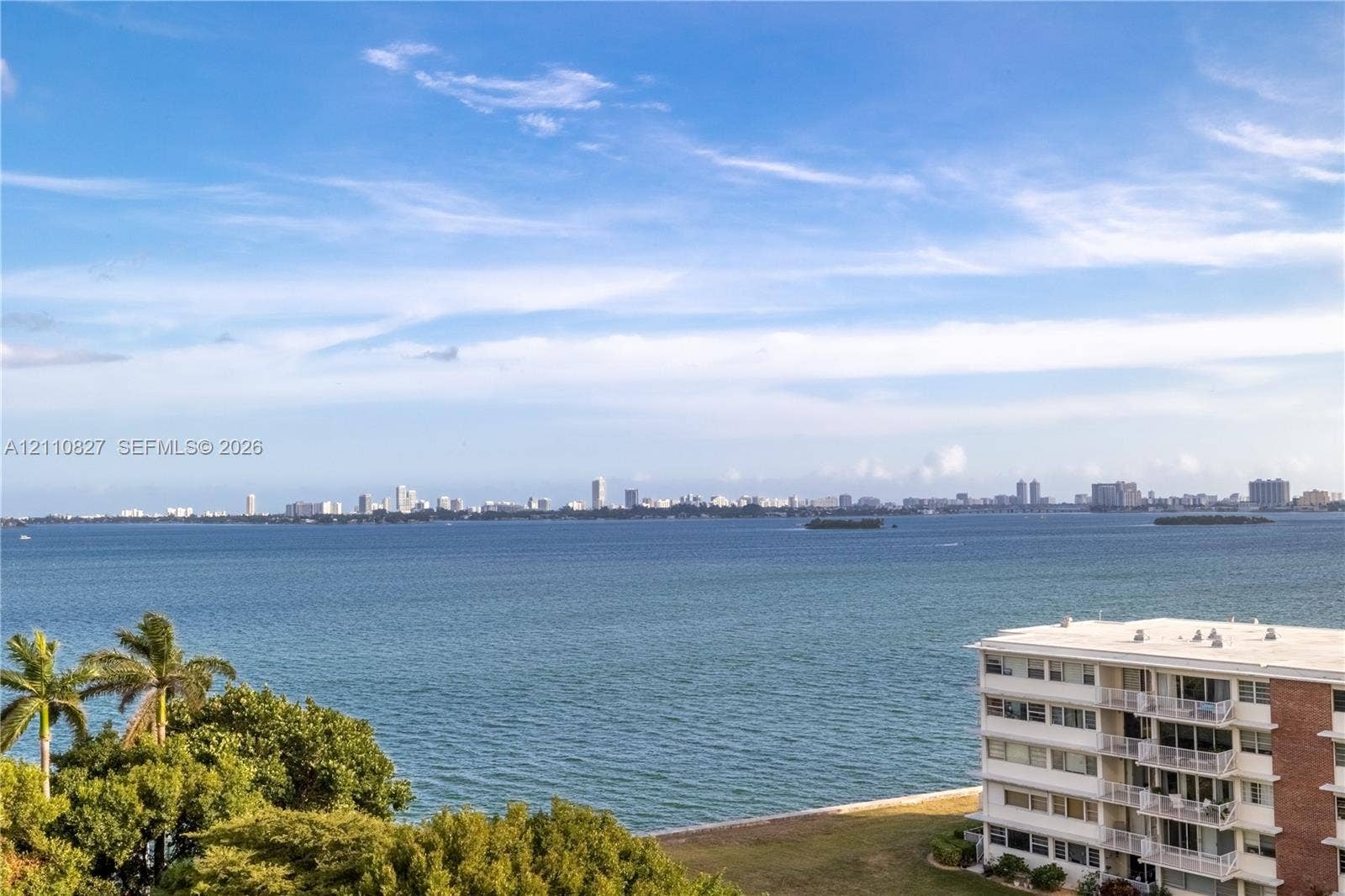 4000 Towerside Terrace, #908, Miami, Miami, FL 33138 Expansive waterfront exposure featuring panoramic bay and city skyline scenery, complemented by mature palm trees and coastal landscaping
