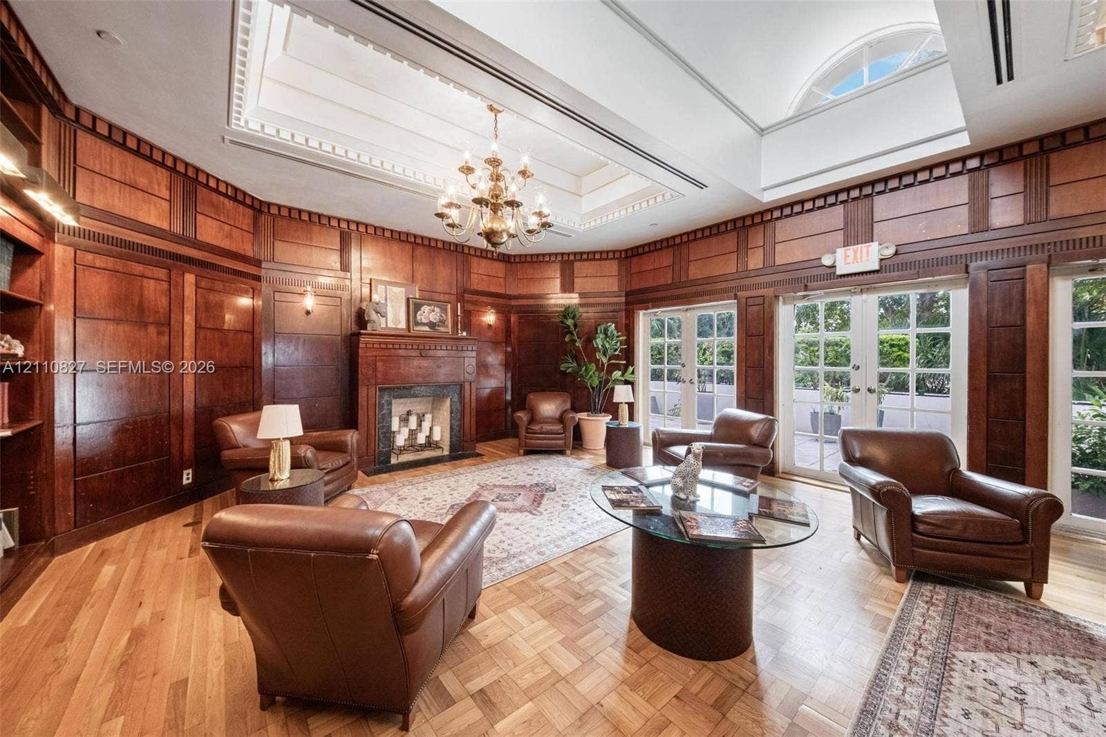 4000 Towerside Terrace, #908, Miami, Miami, FL 33138 Wood-paneled walls, coffered ceiling with integrated skylight, fireplace with masonry surround, parquet wood flooring, and double glass-paned doors