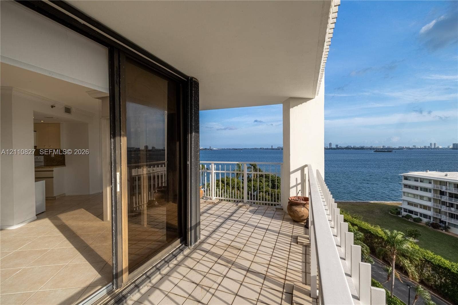 4000 Towerside Terrace, #908, Miami, Miami, FL 33138 Covered balcony featuring tile flooring and a metal railing with water frontage