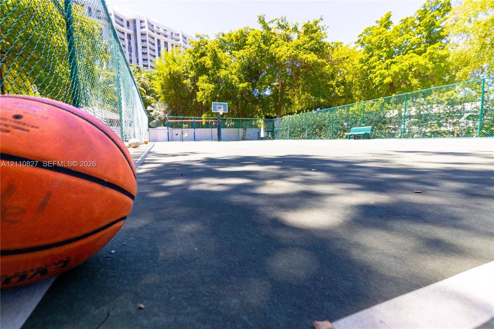 4000 Towerside Terrace, #908, Miami, Miami, FL 33138 Recreational court featuring a hard surface, perimeter chain-link fencing, a basketball hoop, and a fixed bench
