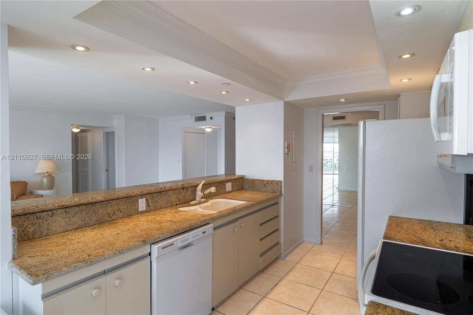 4000 Towerside Terrace, #908, Miami, Miami, FL 33138 Kitchen featuring stone-finish countertops, tile flooring, recessed ceiling lighting, a built-in dishwasher, and a pass-through breakfast bar