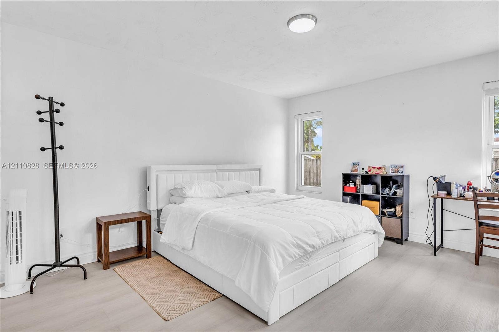 1600 NW 120th Avenue, Pembroke Pines, FL 33026 Neutral-toned wood-finish flooring, two double-hung windows, and a flush-mount overhead light fixture