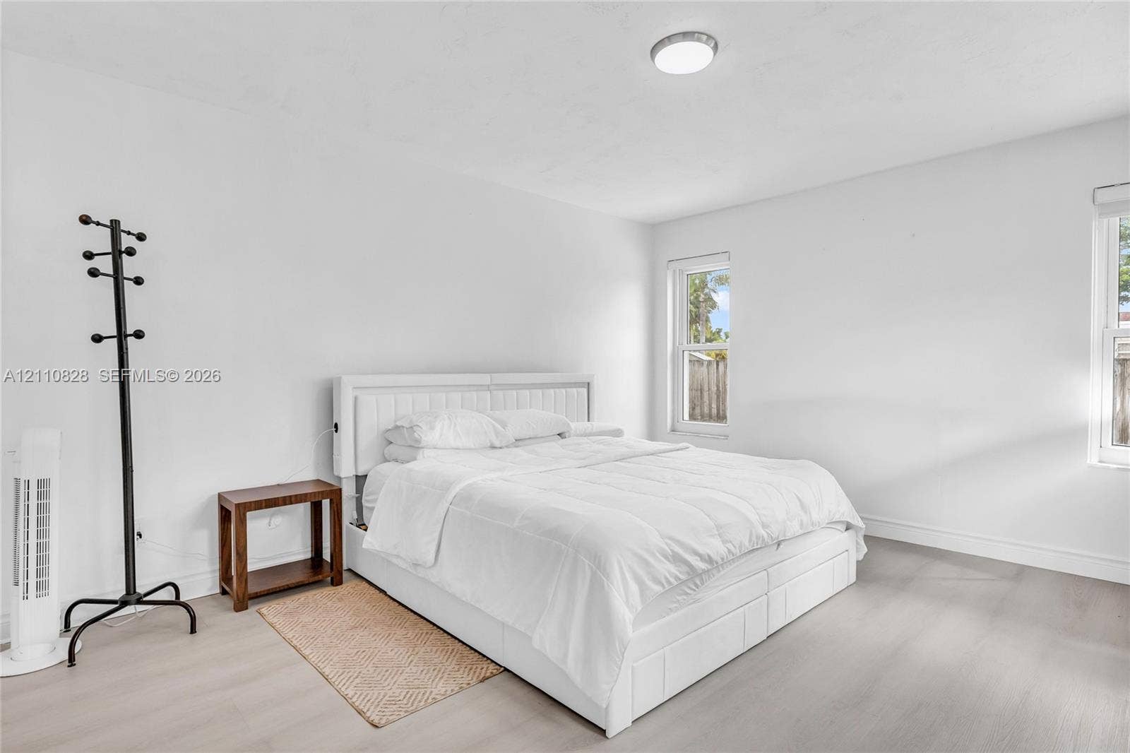 1600 NW 120th Avenue, Pembroke Pines, FL 33026 Neutral-toned wood-finish flooring, two double-pane windows, and a flush-mount ceiling light fixture