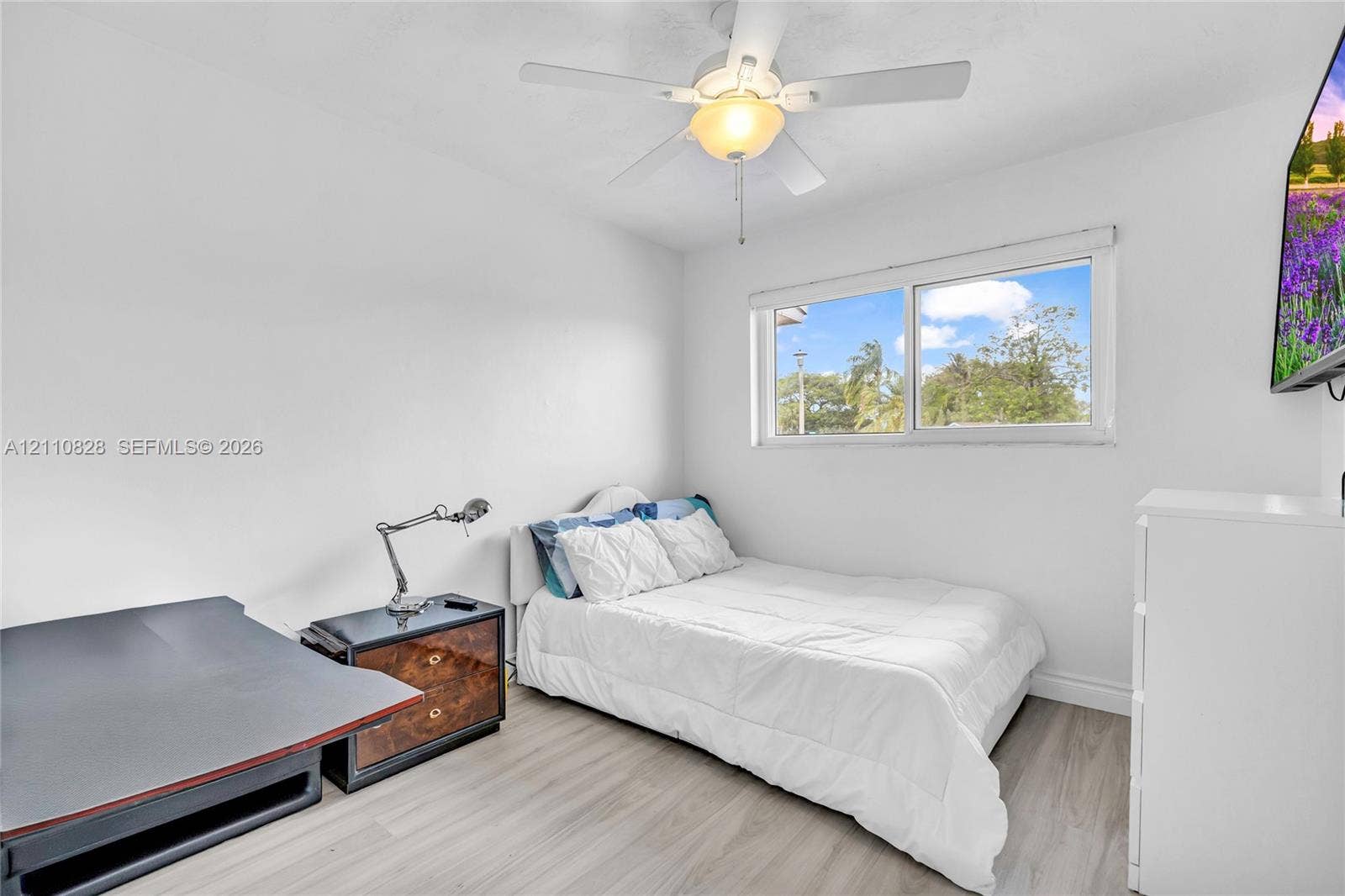 1600 NW 120th Avenue, Pembroke Pines, FL 33026 Neutral interior featuring wood-finish flooring, a ceiling fan with integrated lighting, and a horizontal sliding window