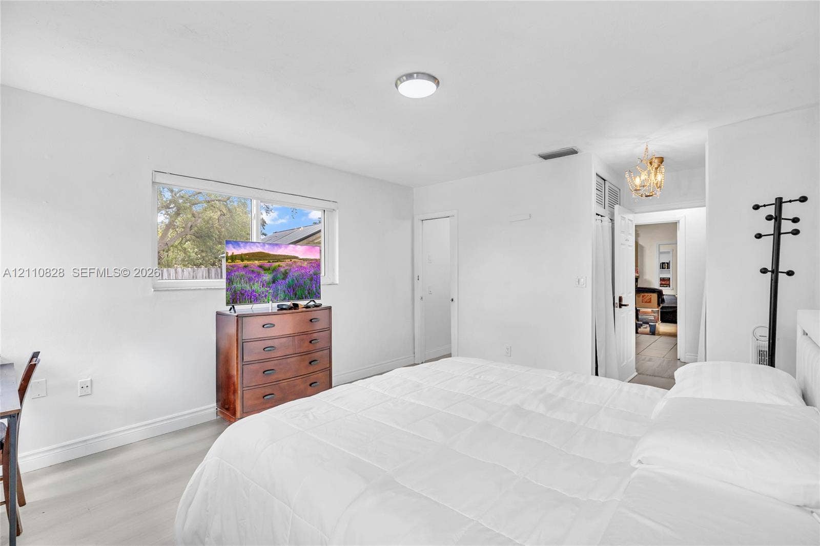 1600 NW 120th Avenue, Pembroke Pines, FL 33026 Neutral wall finishes, wood-finish flooring, recessed ceiling lighting, and a single-pane horizontal window