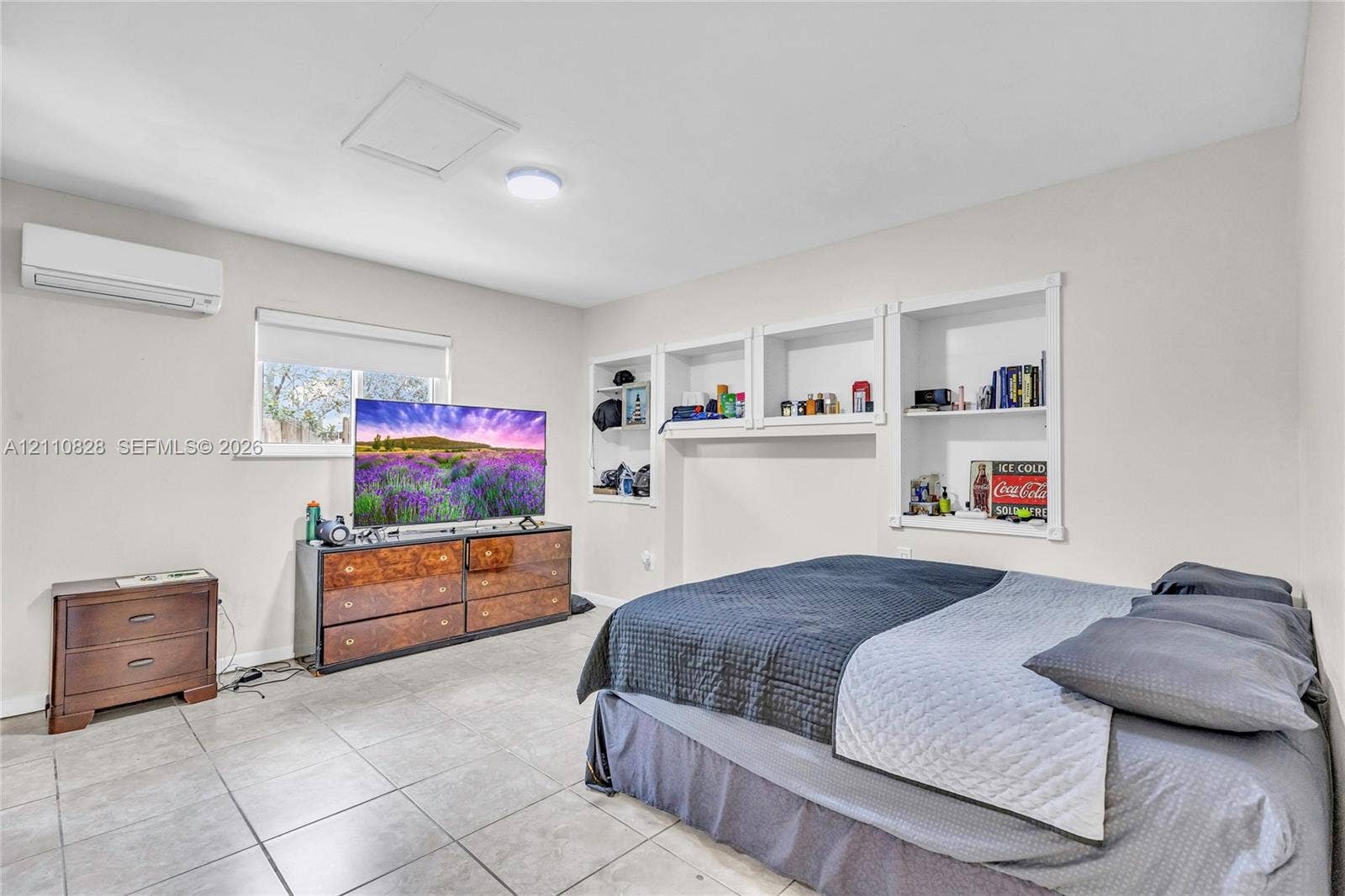 1600 NW 120th Avenue, Pembroke Pines, FL 33026 Neutral interior featuring tile flooring, wall-mounted air conditioning unit, and built-in recessed shelving