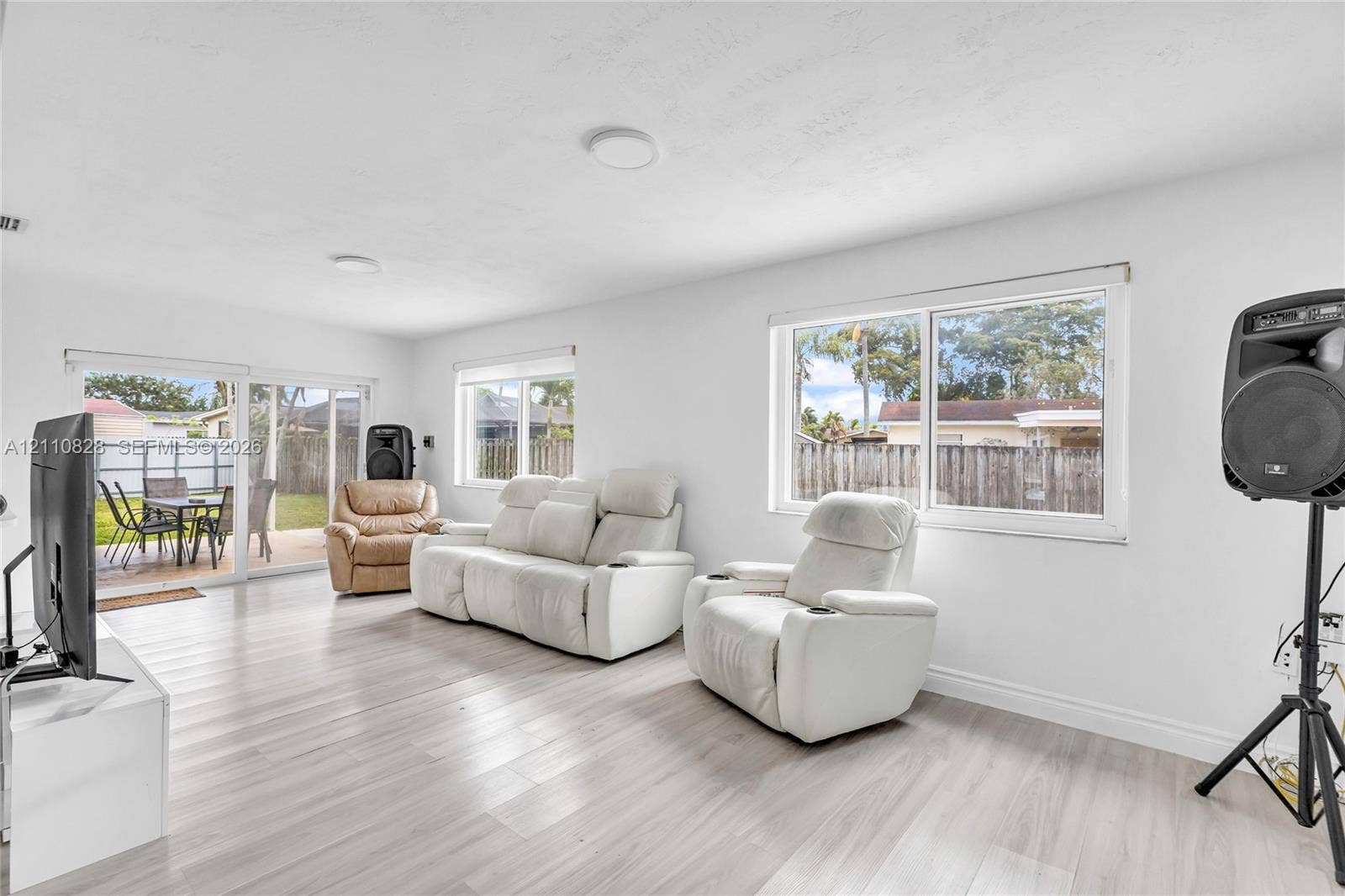 1600 NW 120th Avenue, Pembroke Pines, FL 33026 Living area featuring light-toned wood-finish flooring, white walls, flush-mount ceiling lighting, and horizontal sliding windows