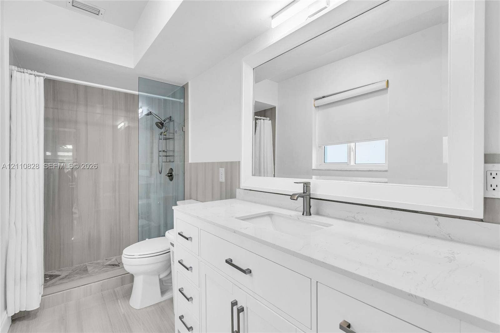 1600 NW 120th Avenue, Pembroke Pines, FL 33026 White shaker-style vanity with a quartz countertop, integrated rectangular sink, brushed-metal faucet, and large-format tile shower surround with a glass enclosure