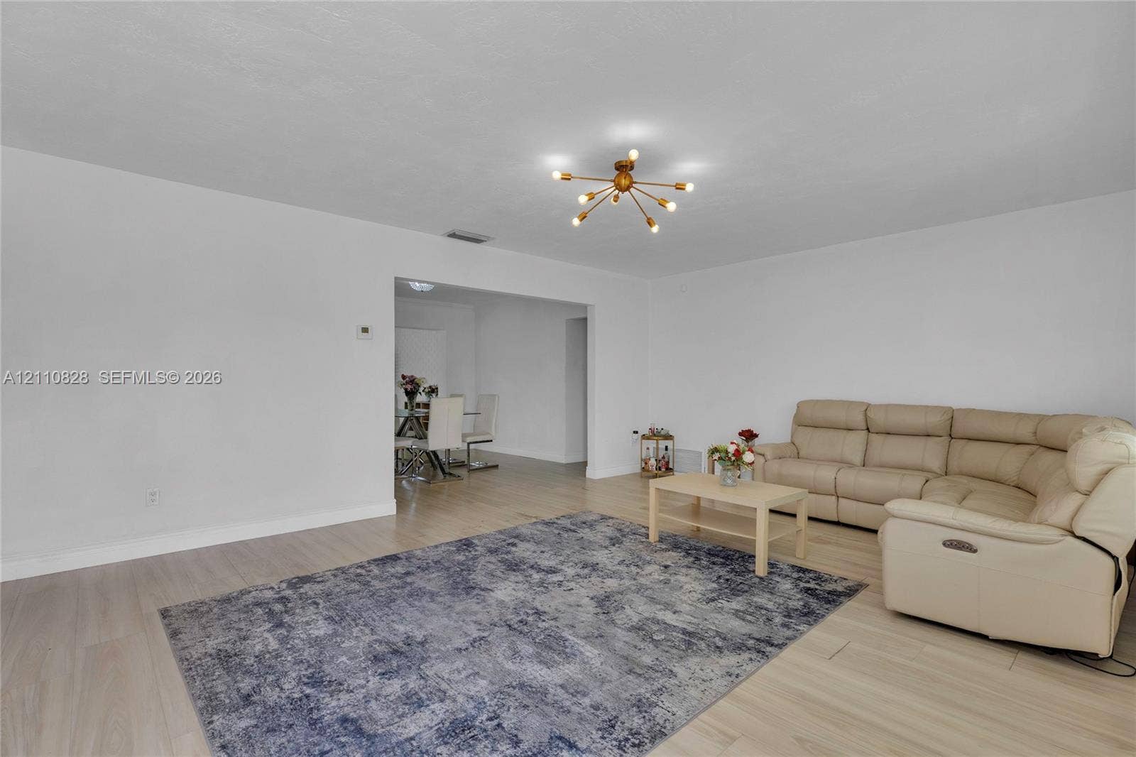 1600 NW 120th Avenue, Pembroke Pines, FL 33026 Living area featuring light-toned wood-finish flooring and a multi-arm geometric ceiling fixture