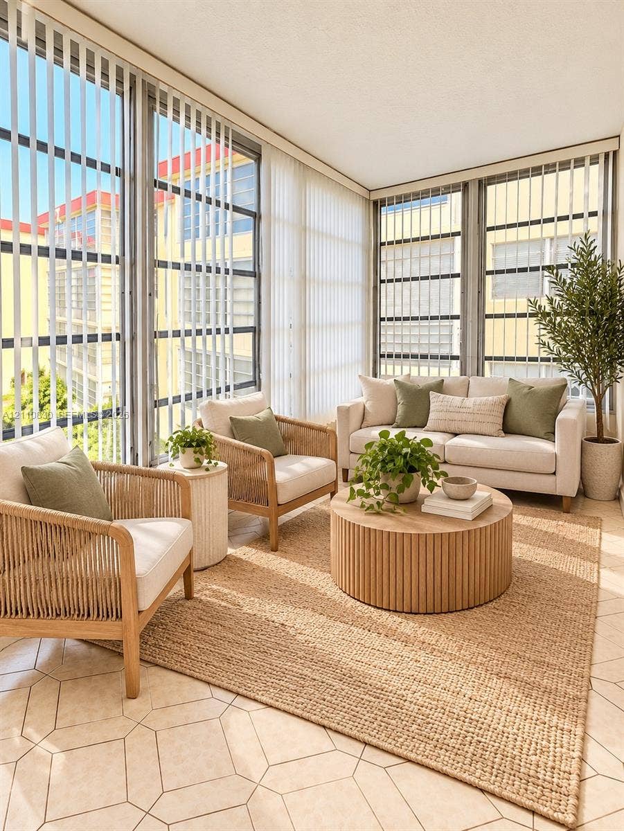 STAGED Sunroom featuring expansive floor-to-ceiling windows, vertical blinds, and geometric-patterned tile flooring