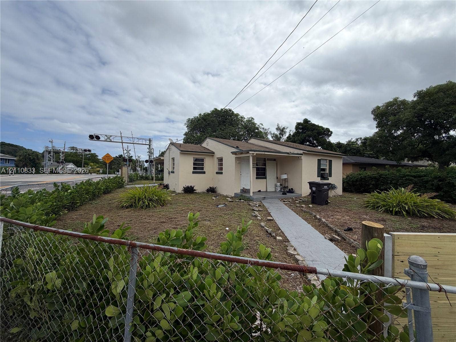 Single-story residence with a stucco exterior, covered front porch, and concrete walkway