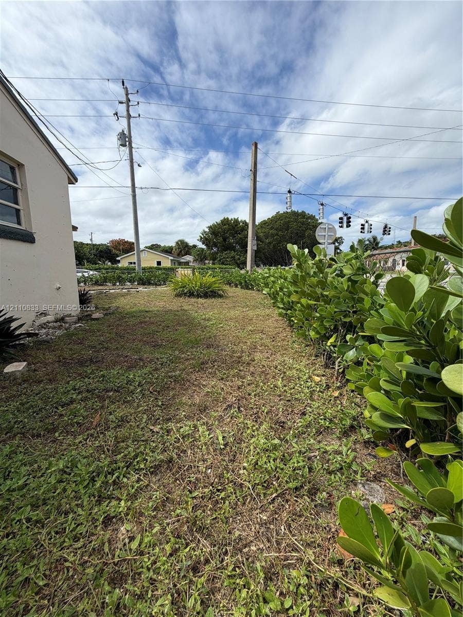 Side yard featuring mature hedges and native landscaping