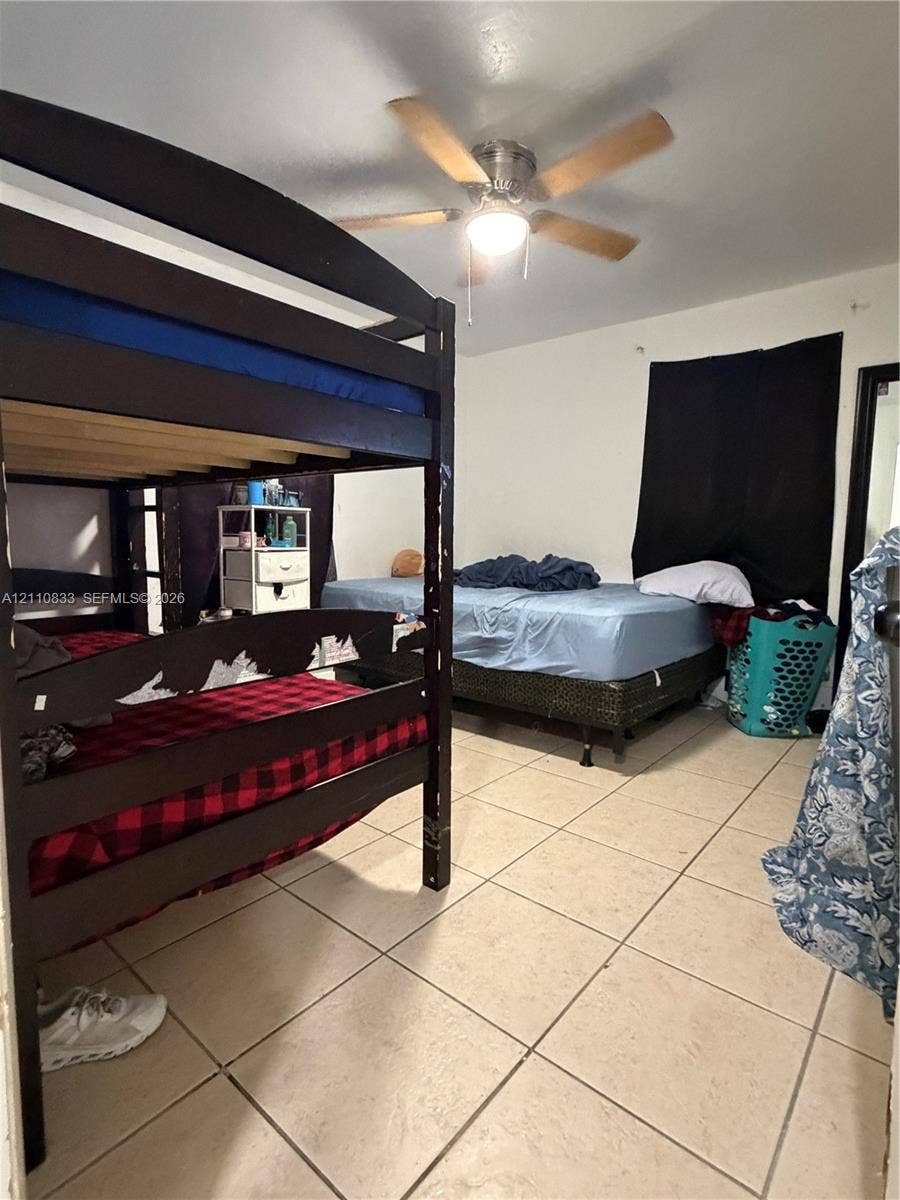 Ceramic tile flooring and a ceiling-mounted light fixture with integrated fan