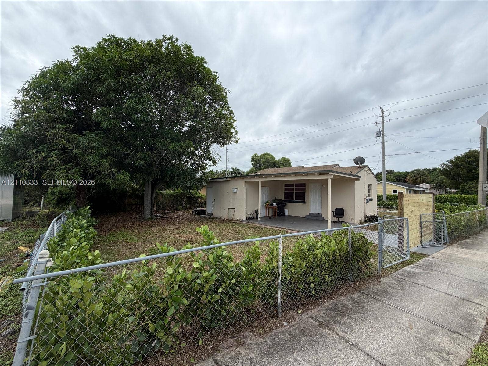 Charming single-story home with a covered front porch and open-air carport