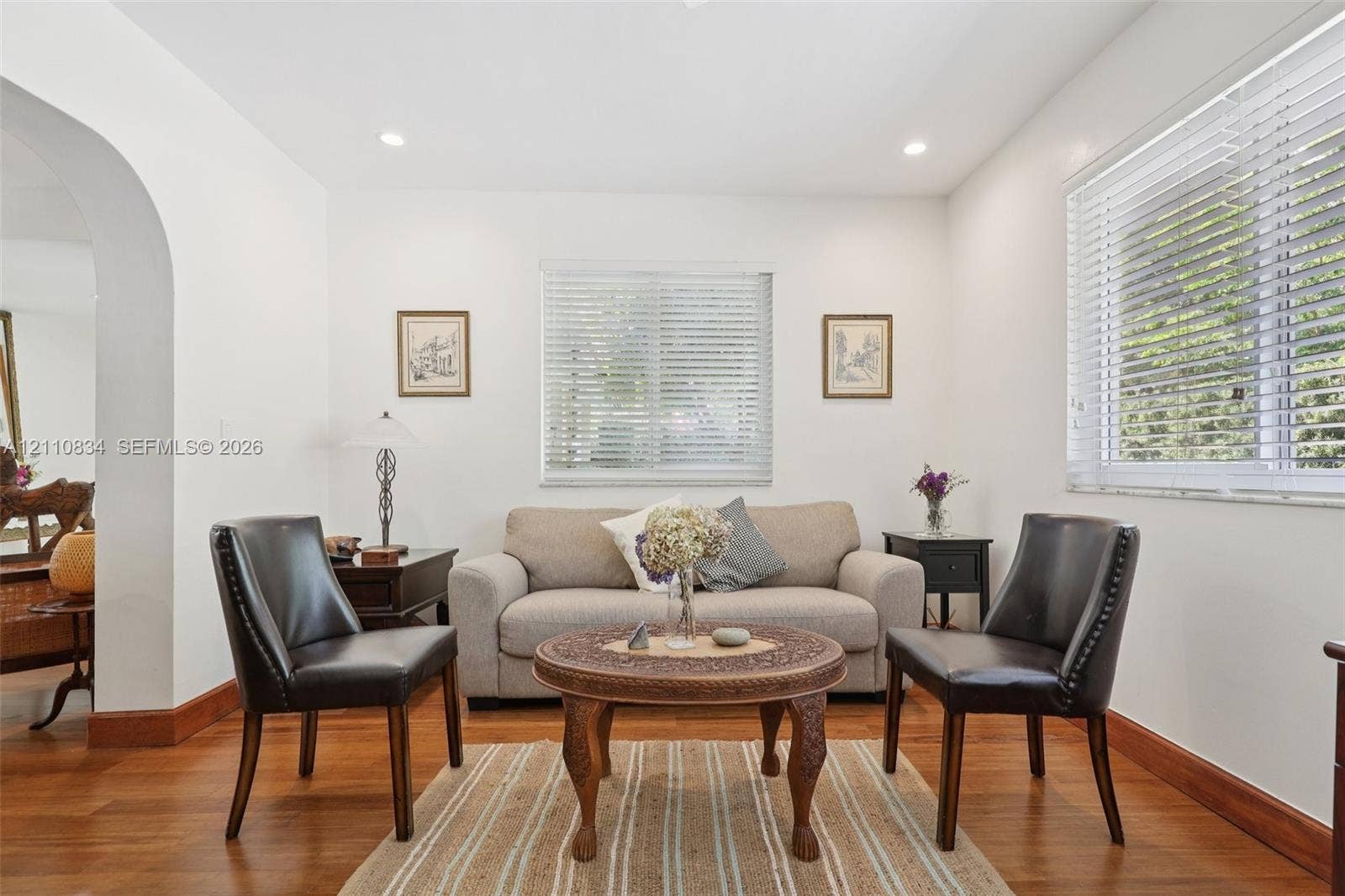 4120 SW 15th Street, Miami, FL 33142 Room featuring wood-finish flooring, recessed lighting, white walls, horizontal window blinds, and an arched architectural opening