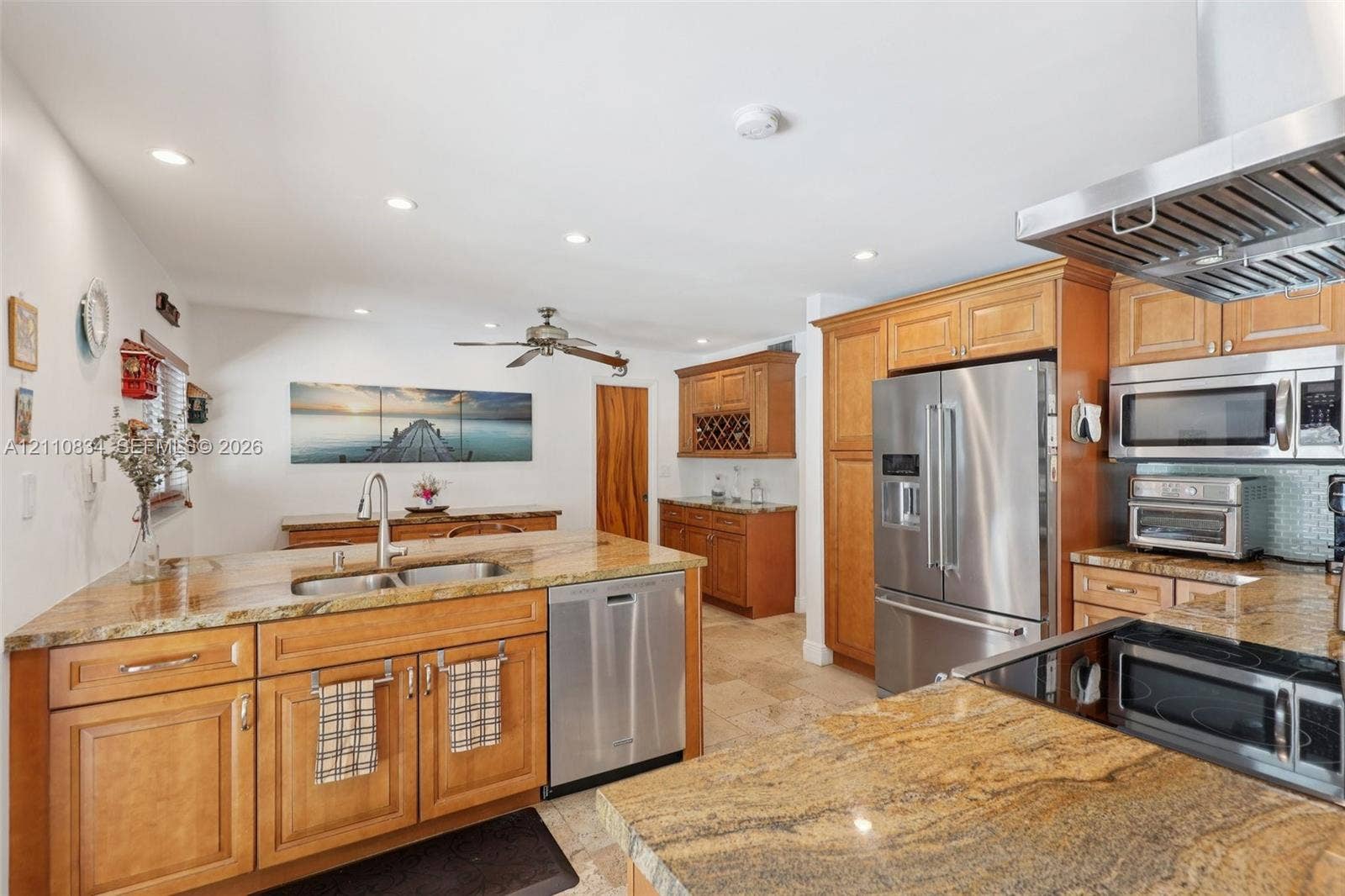 4120 SW 15th Street, Miami, FL 33142 Kitchen featuring wood cabinetry, stone countertops, stainless steel appliances, a dual-basin sink, and recessed lighting