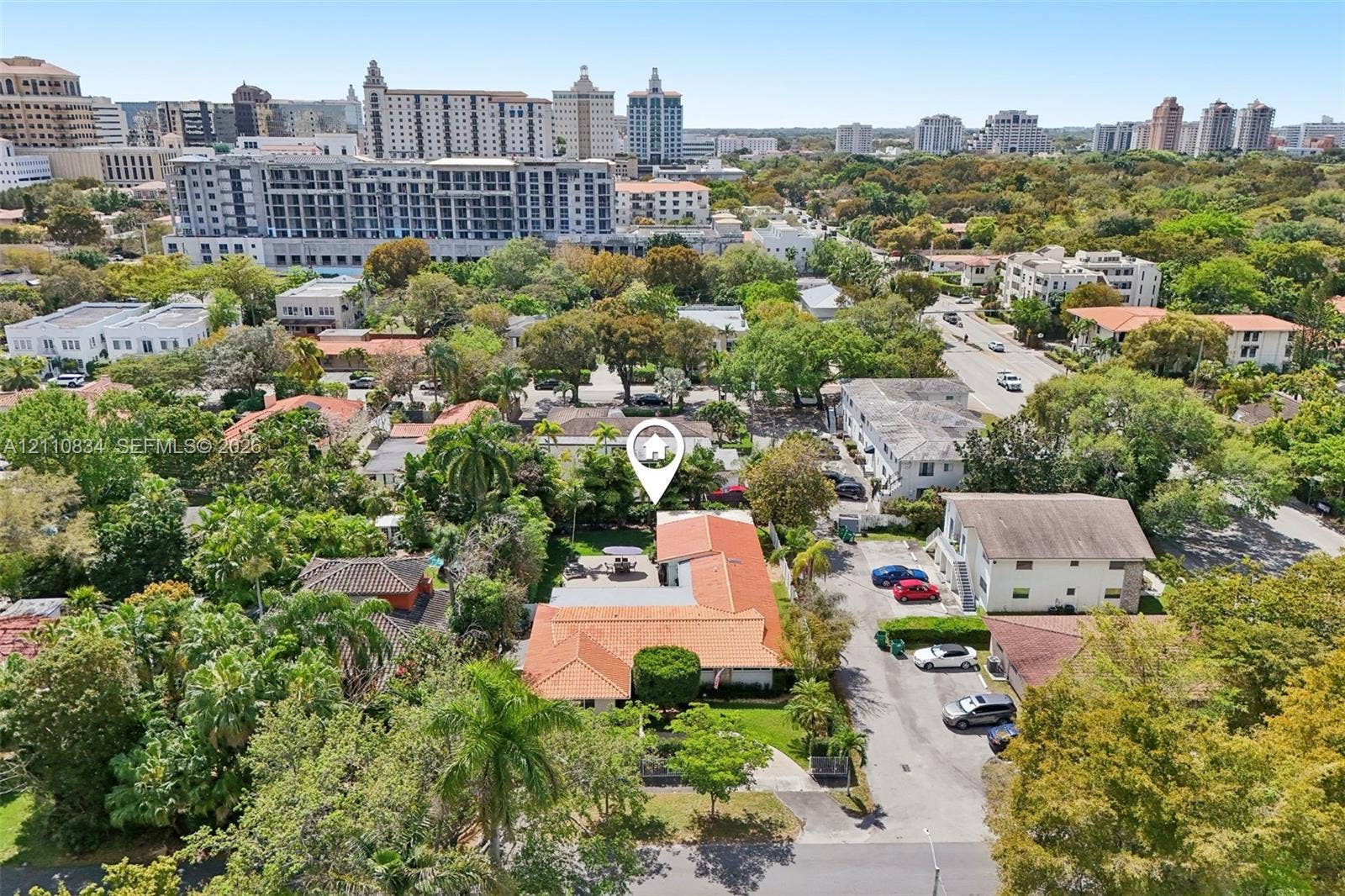 4120 SW 15th Street, Miami, FL 33142 Aerial perspective featuring a terracotta-tiled roof, paved driveway, mature trees, and landscaping