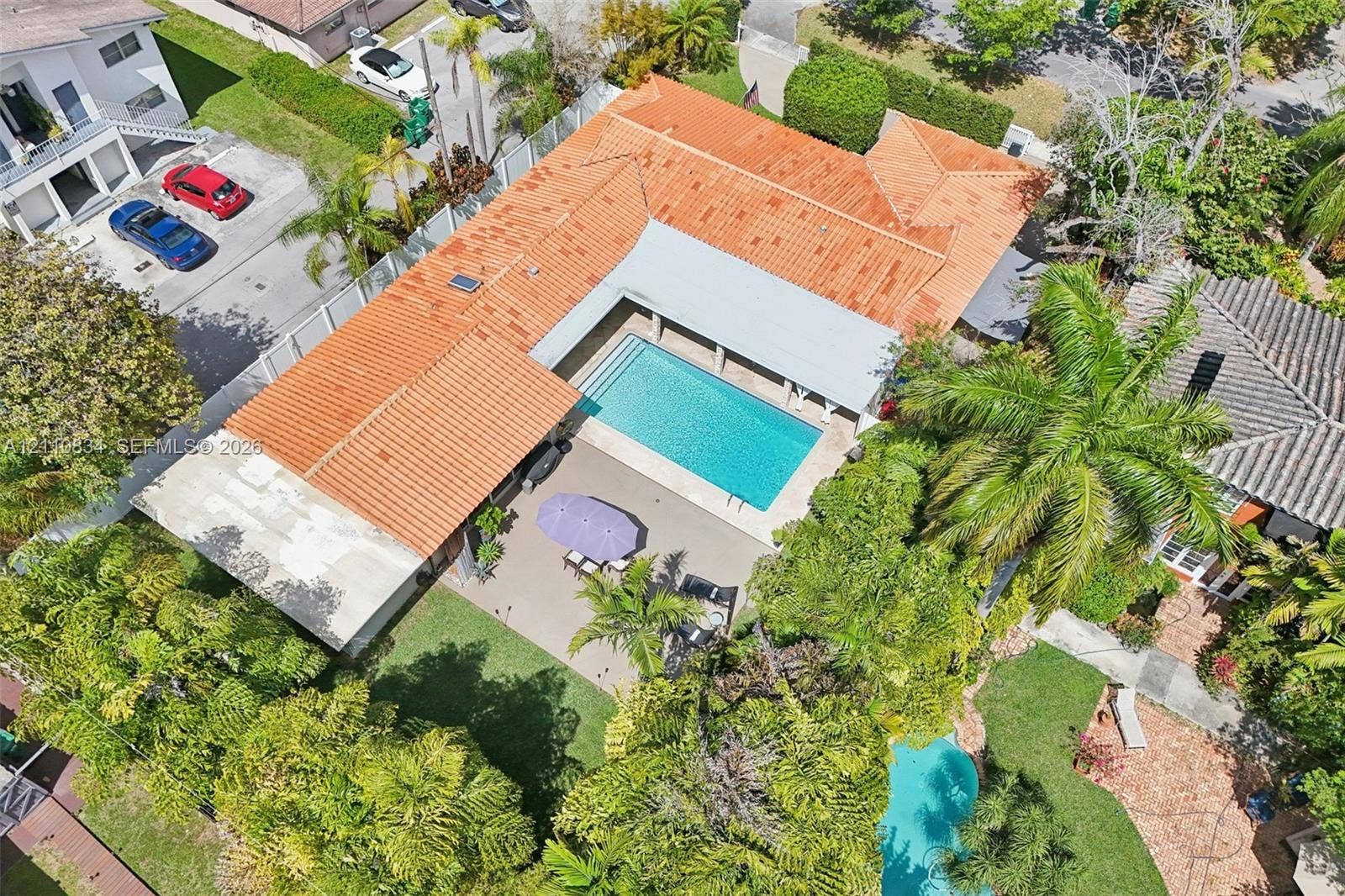 4120 SW 15th Street, Miami, FL 33142 Aerial view featuring a tile roof, an in-ground swimming pool, a covered patio, and landscaped grounds