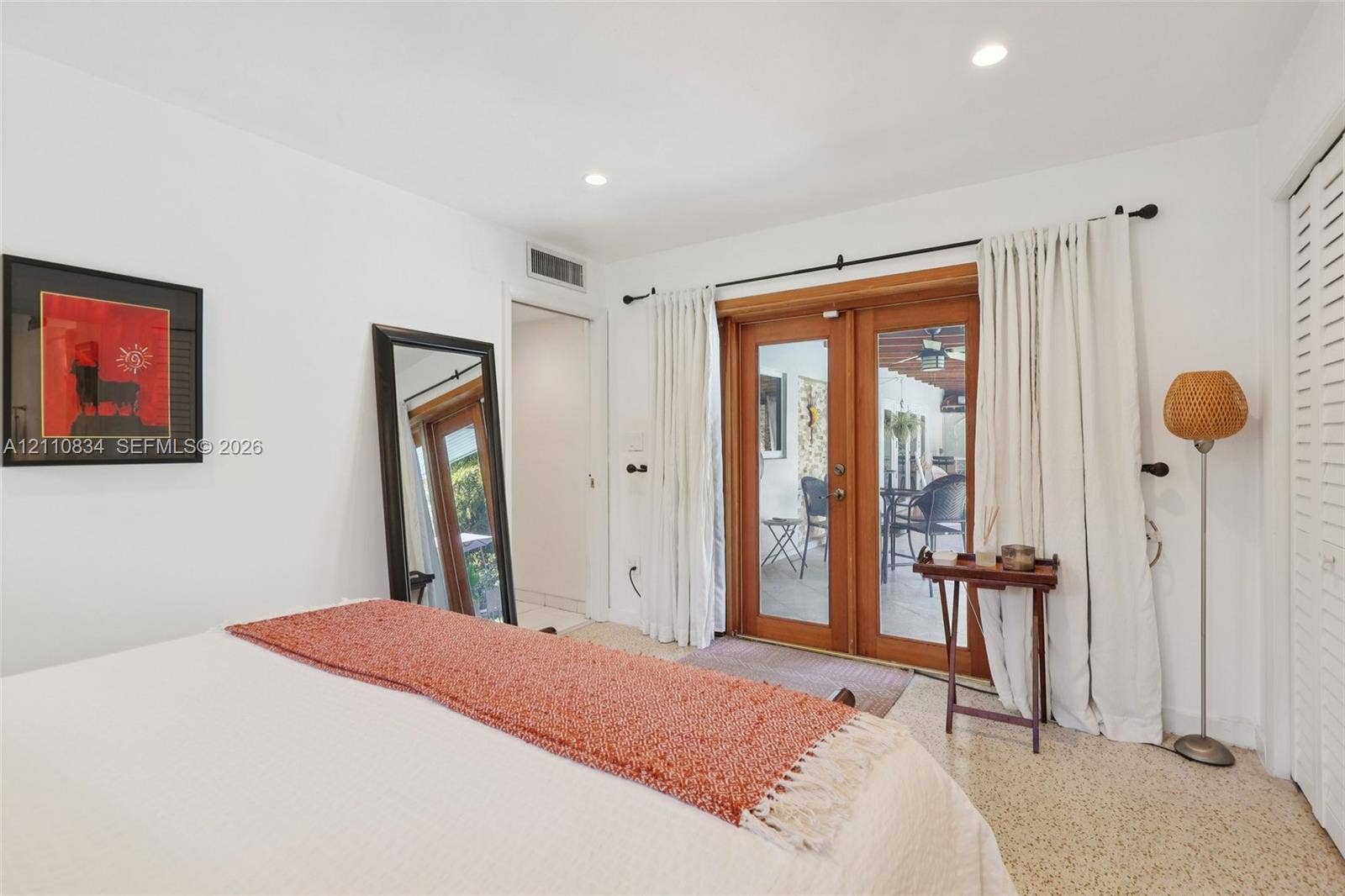4120 SW 15th Street, Miami, FL 33142 Interior space featuring glass-paned wood-framed double doors, recessed lighting, and terrazzo flooring