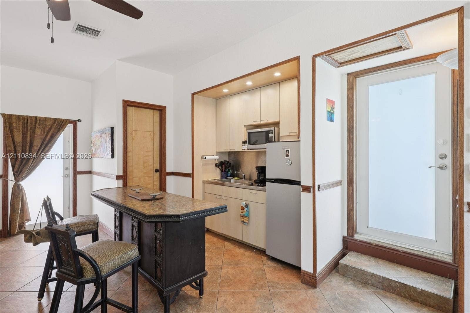 4120 SW 15th Street, Miami, FL 33142 Kitchenette featuring light-finish cabinetry, stone-top counter island, ceramic tile flooring, built-in recessed lighting, and exterior doors