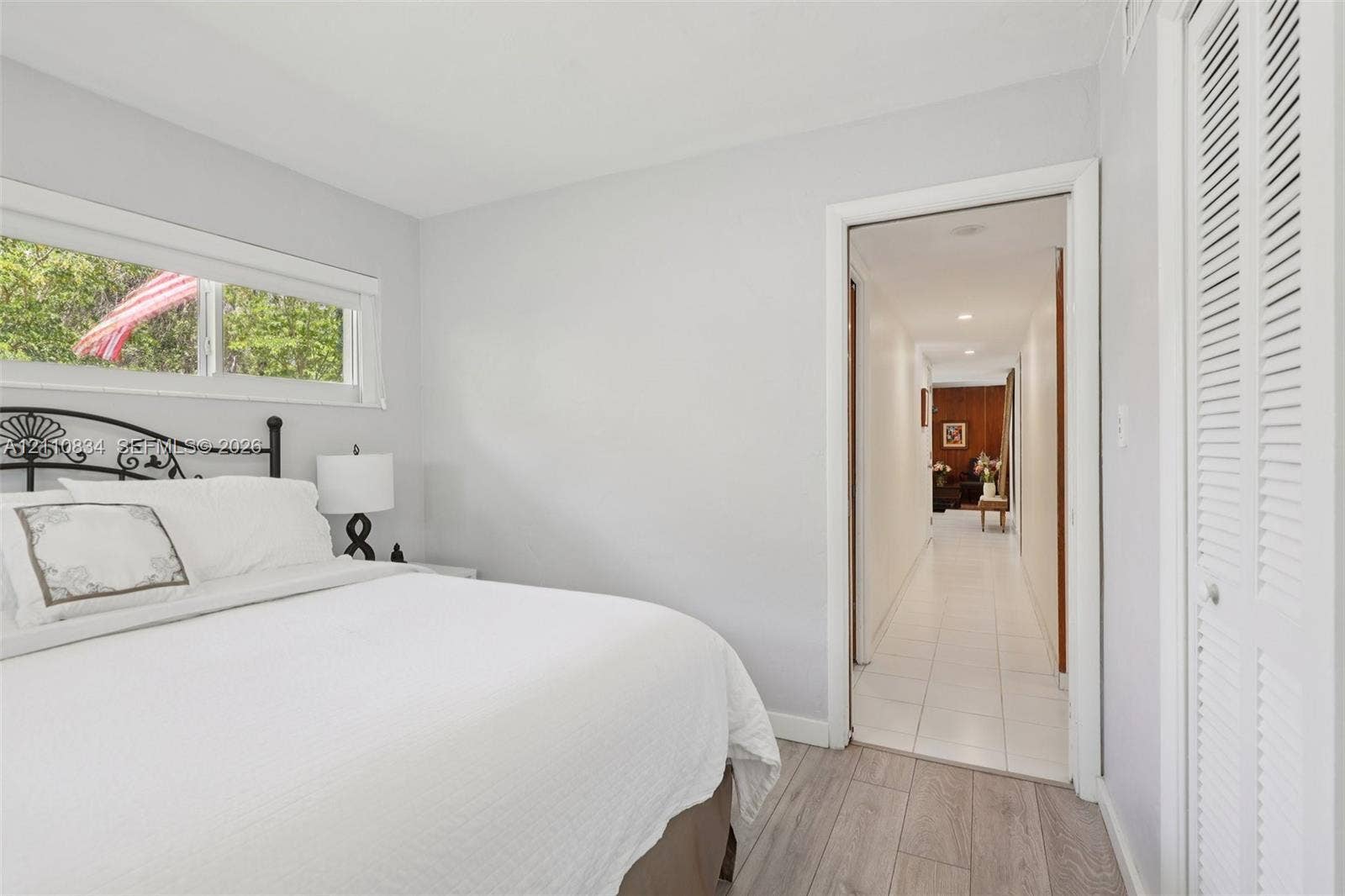 4120 SW 15th Street, Miami, FL 33142 Wood-finish flooring, horizontal sliding window, and louvered closet doors