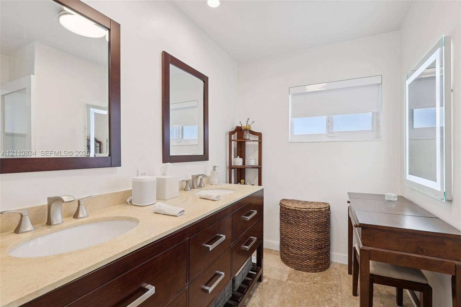 4120 SW 15th Street, Miami, FL 33142 Double vanity with dark wood cabinetry, light-toned stone countertop, dual undermount sinks, and polished chrome fixtures
