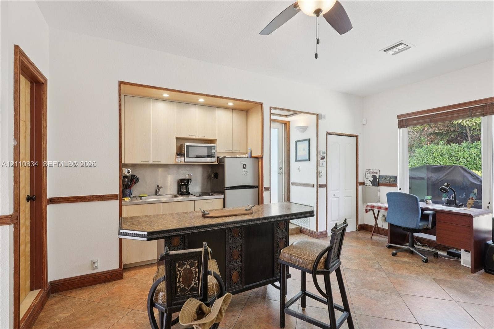 4120 SW 15th Street, Miami, FL 33142 Kitchen featuring custom light-finish cabinetry, recessed lighting, tile flooring, and a built-in island with decorative detailing