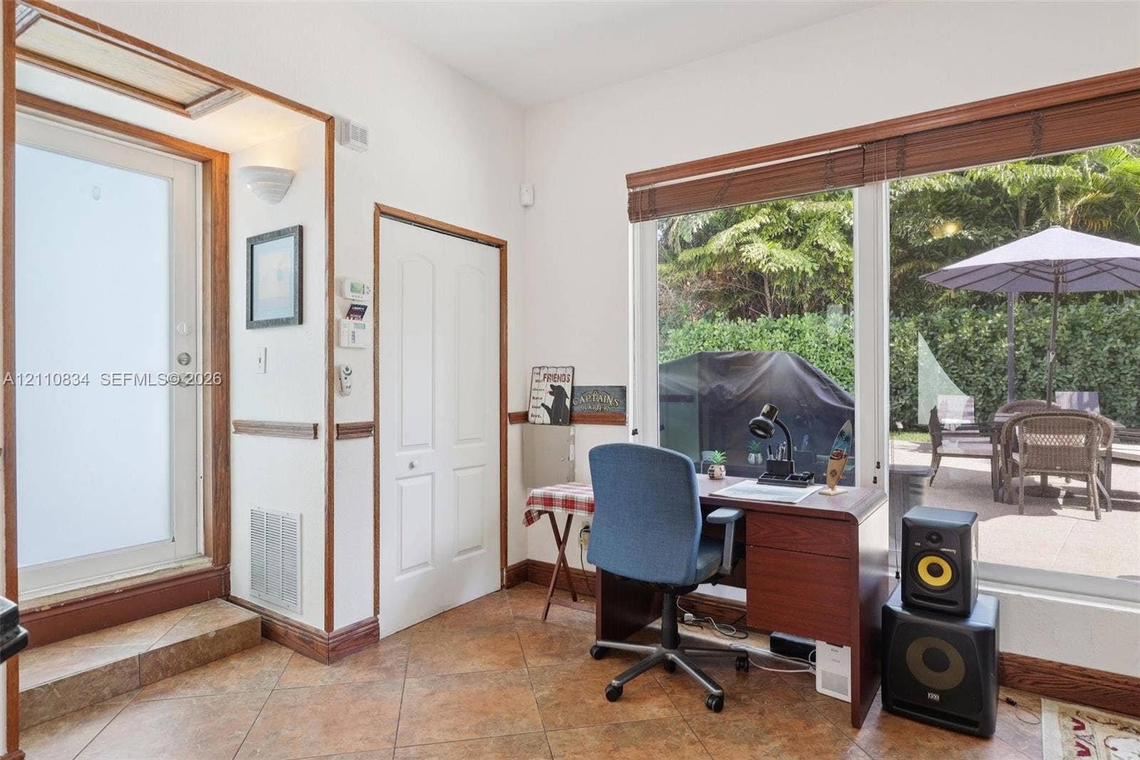 4120 SW 15th Street, Miami, FL 33142 Tile flooring, wood-trimmed door frames, and a large sliding glass door