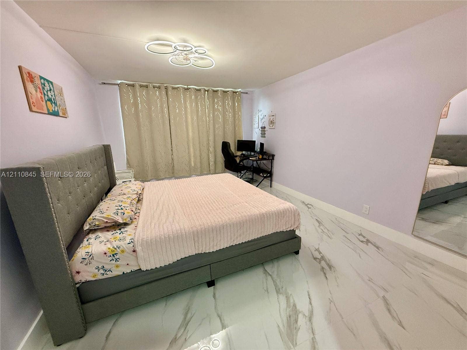 565 Oaks Lane, #410, Pompano Beach, FL 33069 Large-format tile flooring with a veined pattern, arched doorway, and contemporary circular LED flush-mount lighting