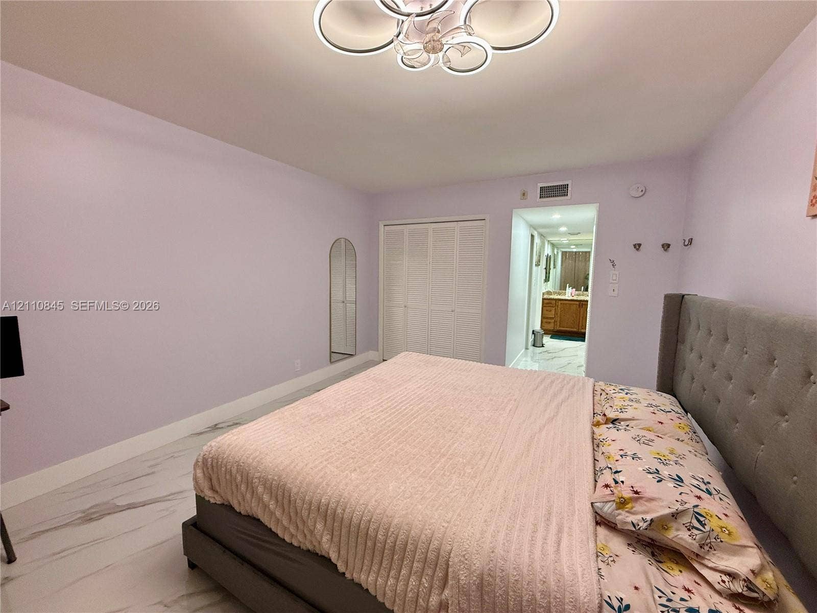 565 Oaks Lane, #410, Pompano Beach, FL 33069 Large-format tile flooring, multi-light contemporary ceiling fixture, and dual bi-fold closet doors