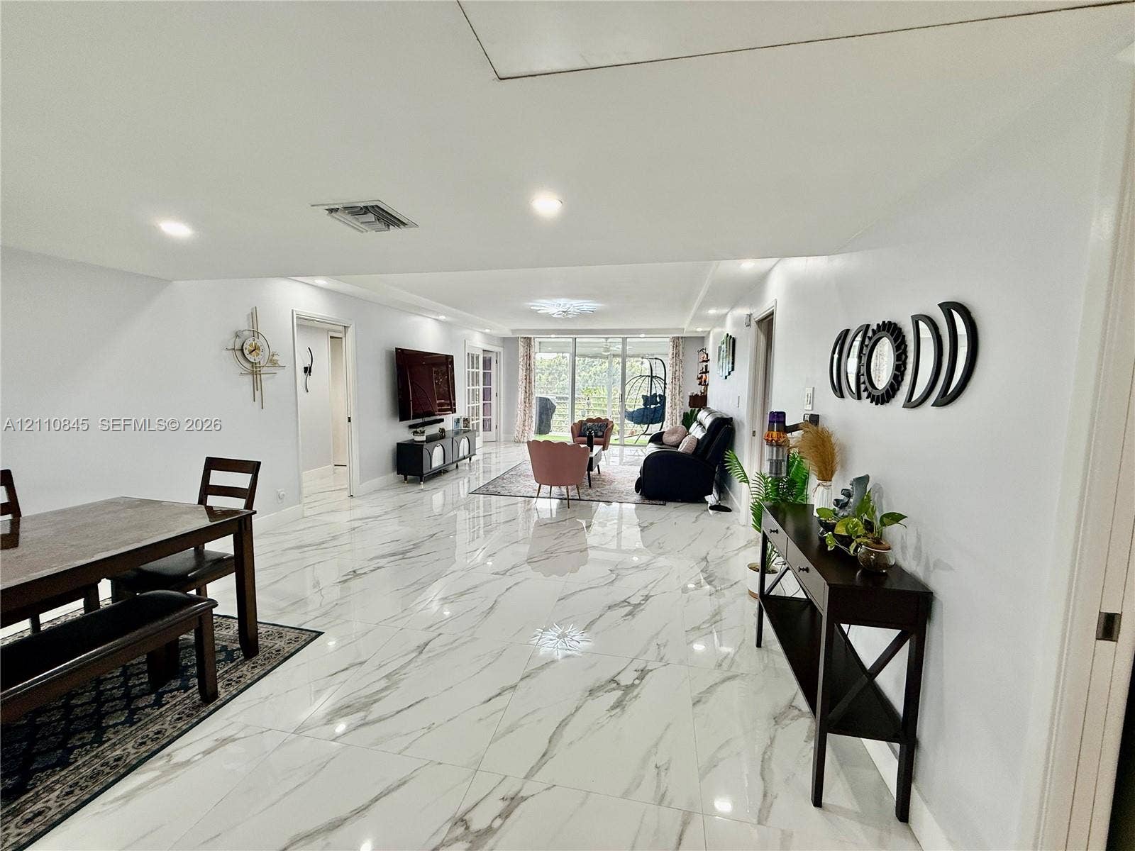 565 Oaks Lane, #410, Pompano Beach, FL 33069 Large-format tile flooring, recessed lighting, and expansive glass sliding doors