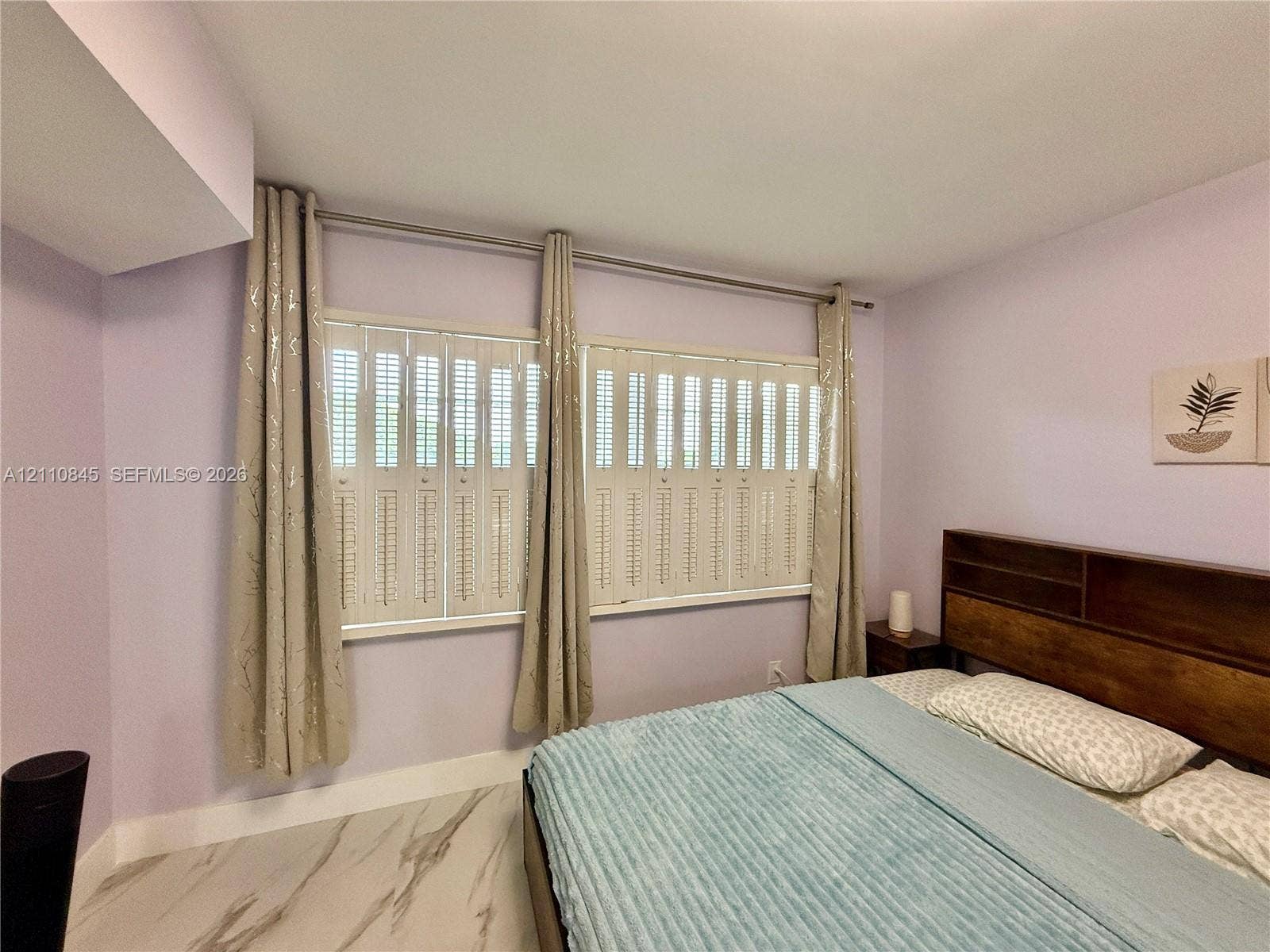 565 Oaks Lane, #410, Pompano Beach, FL 33069 Large windows featuring interior plantation-style shutters and polished stone-finish flooring