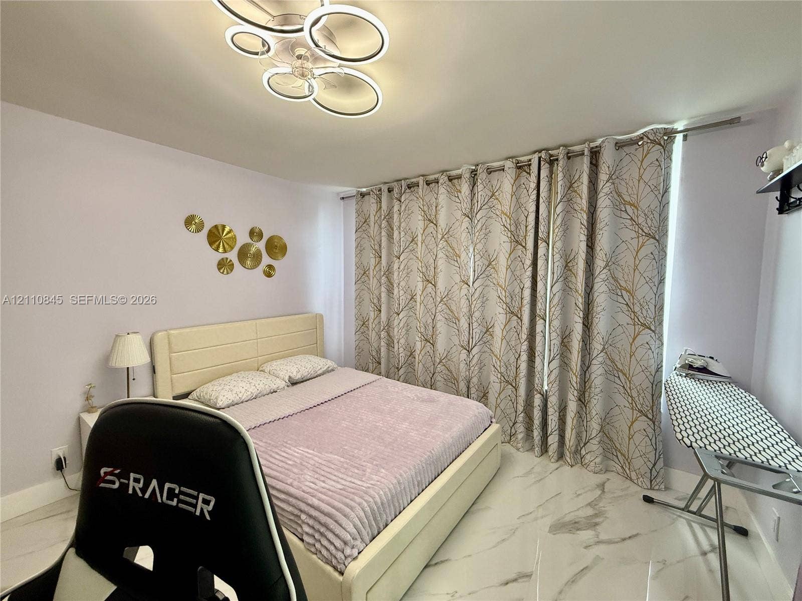 565 Oaks Lane, #410, Pompano Beach, FL 33069 Contemporary multi-ring LED flush-mount ceiling light and polished stone-finish flooring