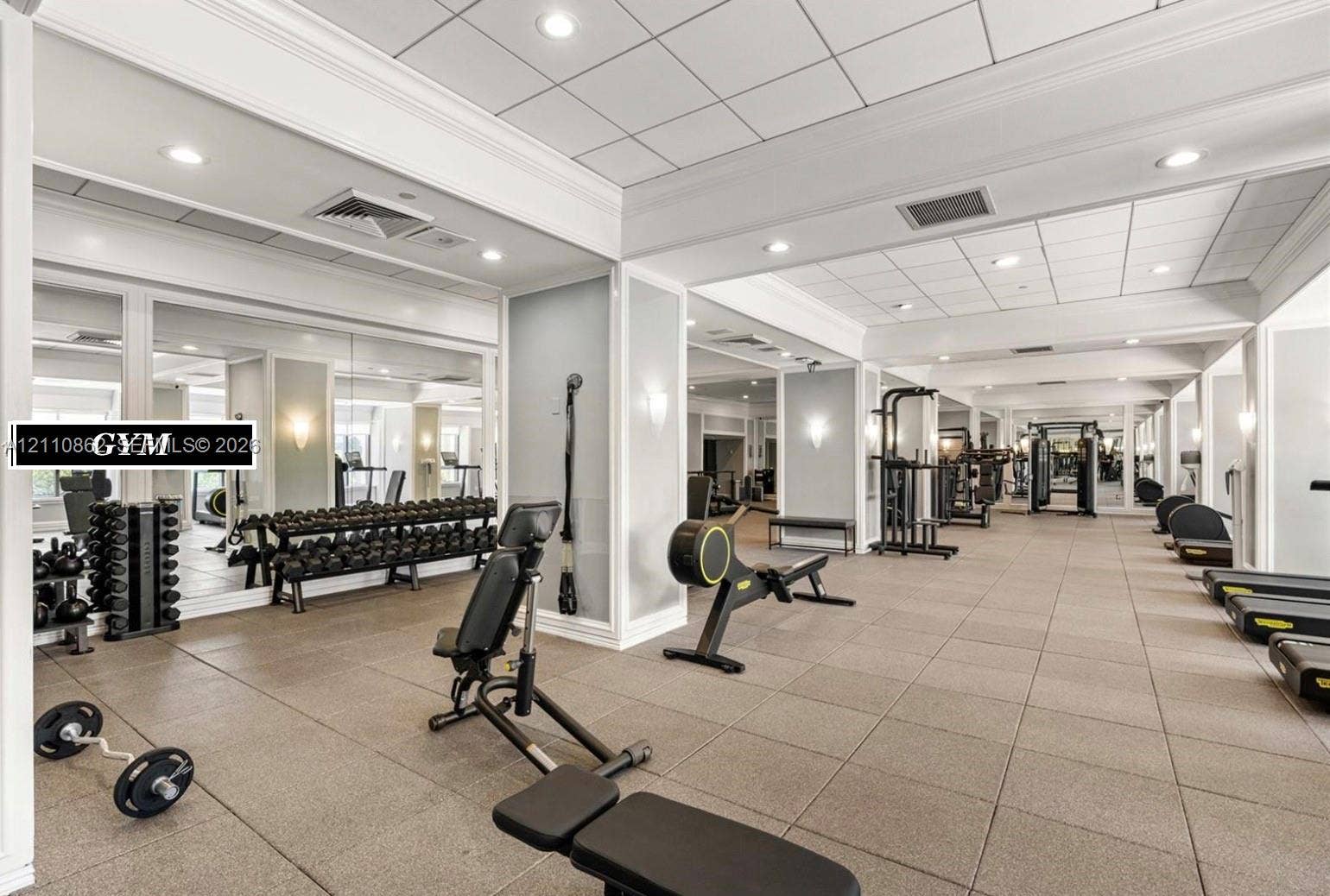 9801 Collins Avenue, #8T, Bal Harbour, Bal Harbour, FL 33154 Fitness space featuring expansive wall mirrors, recessed ceiling lighting, crown molding, and tiled flooring