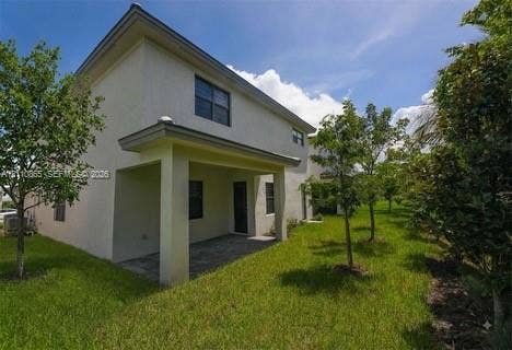 17552 SW 46th Street, Miramar, Miramar, FL 33029 Two-story exterior featuring a covered patio, paved hardscaping, and landscaped green space