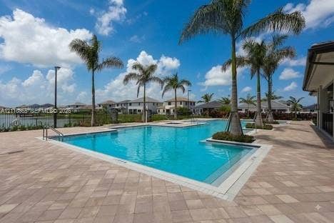 17552 SW 46th Street, Miramar, Miramar, FL 33029 Swimming pool with integrated spa and stone-paver decking, accented by palm trees