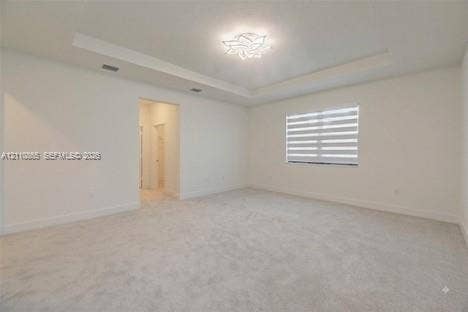 17552 SW 46th Street, Miramar, Miramar, FL 33029 Interior space featuring a tray ceiling, recessed lighting, carpeted flooring, and window shades