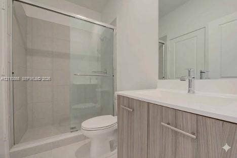 17552 SW 46th Street, Miramar, Miramar, FL 33029 Bathroom featuring a vanity with a light wood-finish cabinet and an integrated countertop, a glass-enclosed shower with tiled surround, and a wall-mounted mirror