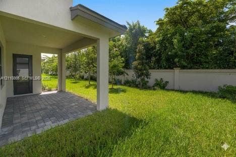 17552 SW 46th Street, Miramar, Miramar, FL 33029 Covered patio with paver flooring, expansive lawn, and concrete privacy wall
