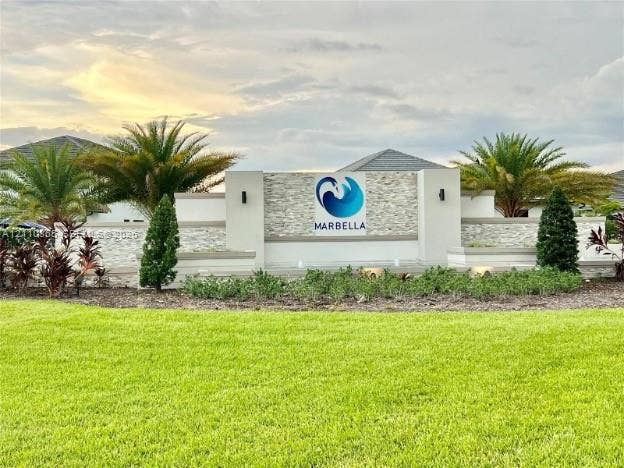 17552 SW 46th Street, Miramar, Miramar, FL 33029 Community entrance monument featuring stacked stone masonry, integrated wall lighting, water features, and manicured tropical landscaping