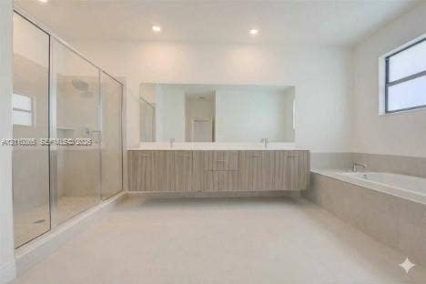 17552 SW 46th Street, Miramar, Miramar, FL 33029 Floating vanity with double under-mount sinks, expansive wall-to-wall mirror, glass-enclosed walk-in shower, built-in soaking tub with stone surround, and recessed lighting