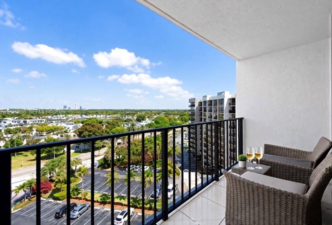 Covered balcony featuring tile flooring and a black metal railing