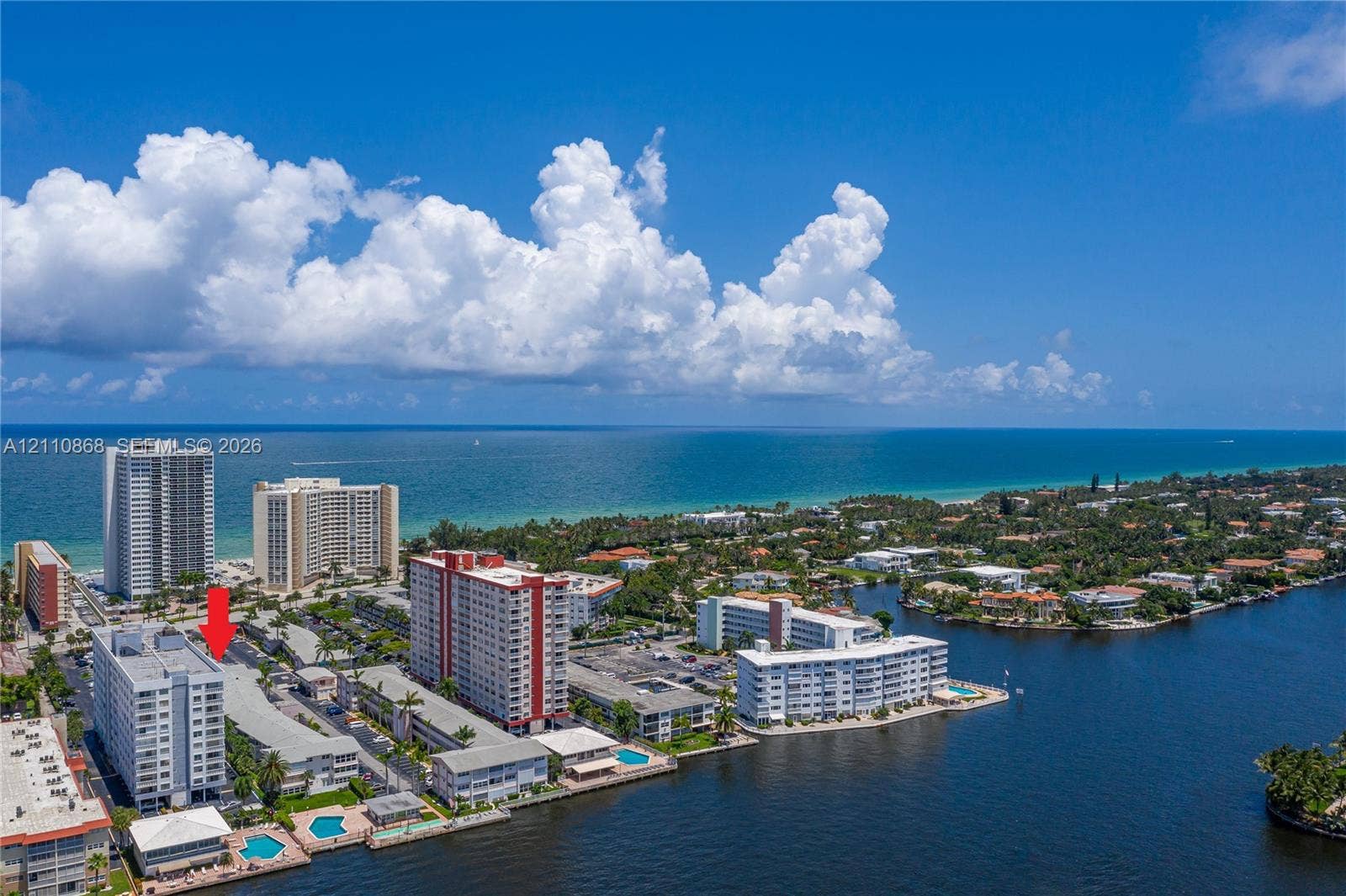 3121 S Ocean Drive, #209, Hallandale Beach, FL 33009 Aerial perspective of coastal residential property featuring proximity to the shoreline, direct water access, and exterior swimming pool facilities