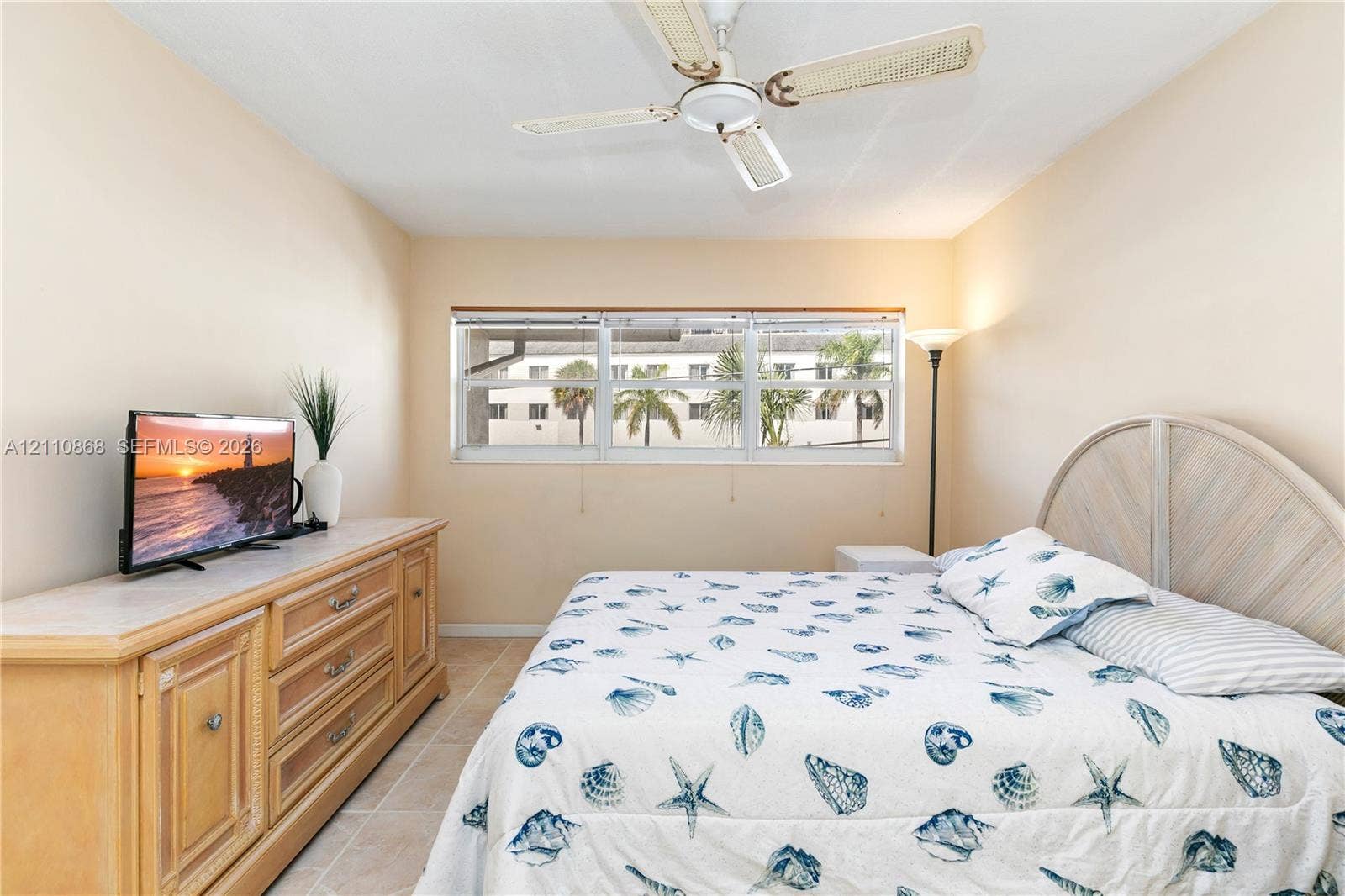 3121 S Ocean Drive, #209, Hallandale Beach, FL 33009 Neutral wall tones, horizontal sliding windows, tile flooring, and a ceiling fan
