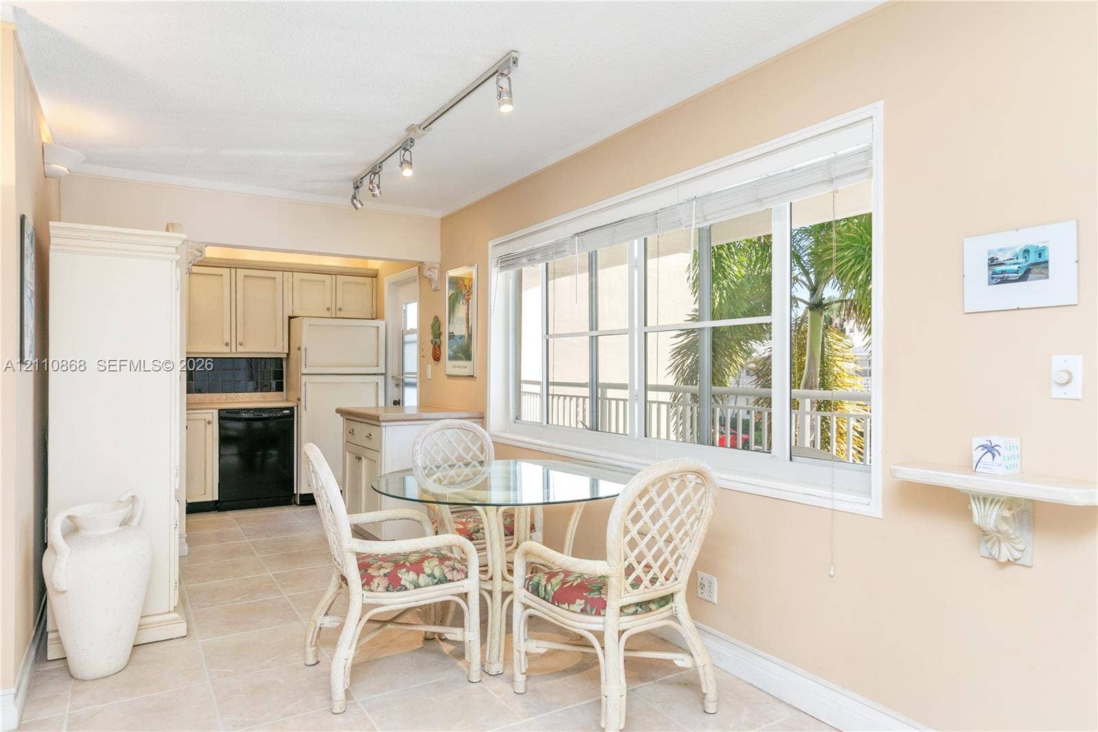 3121 S Ocean Drive, #209, Hallandale Beach, FL 33009 Kitchen featuring light-toned cabinetry, ceramic tile flooring, horizontal sliding windows, and adjustable track lighting