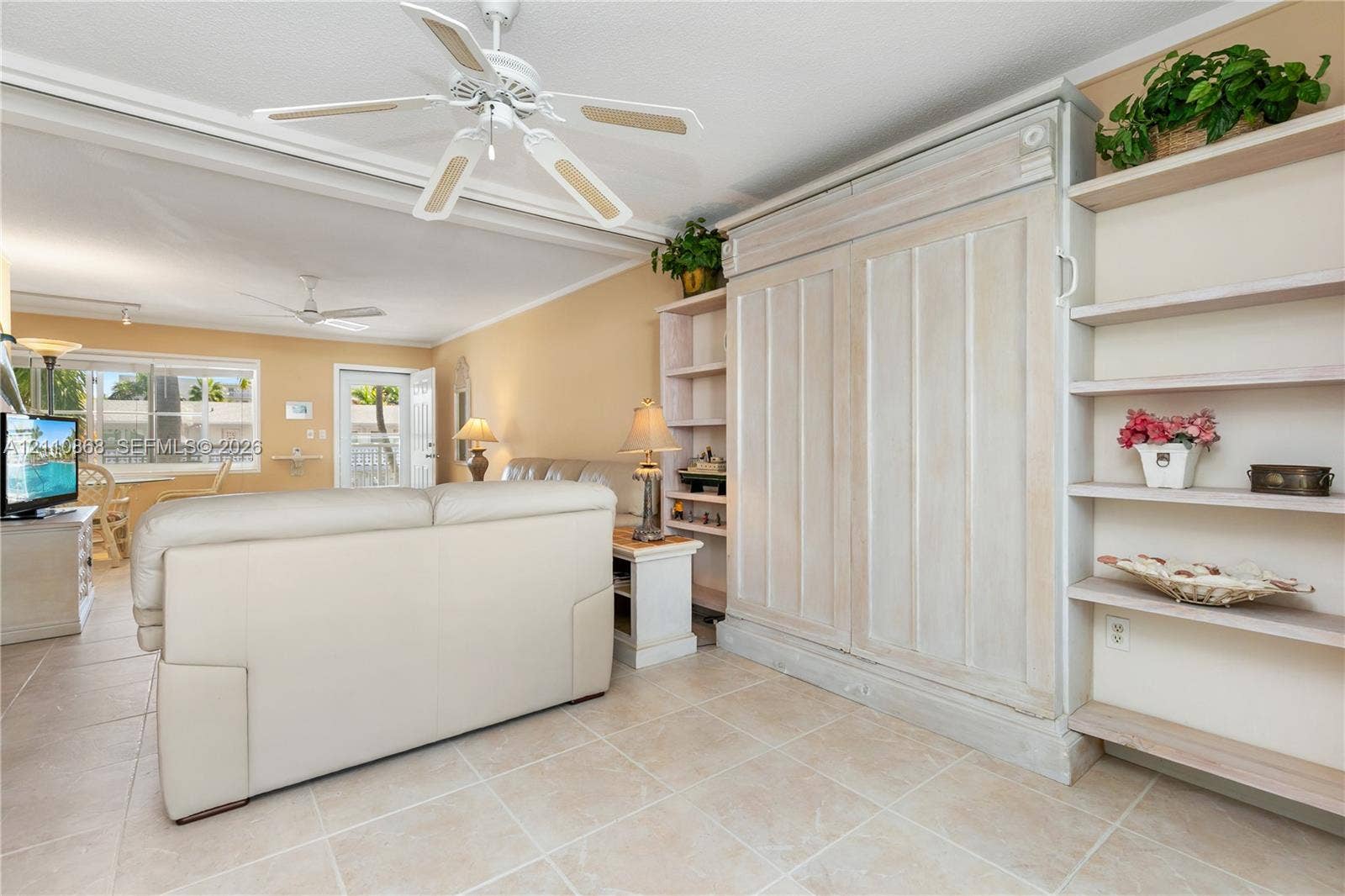 3121 S Ocean Drive, #209, Hallandale Beach, FL 33009 Built-in cabinetry with integrated shelving, tile flooring, and ceiling-mounted fans