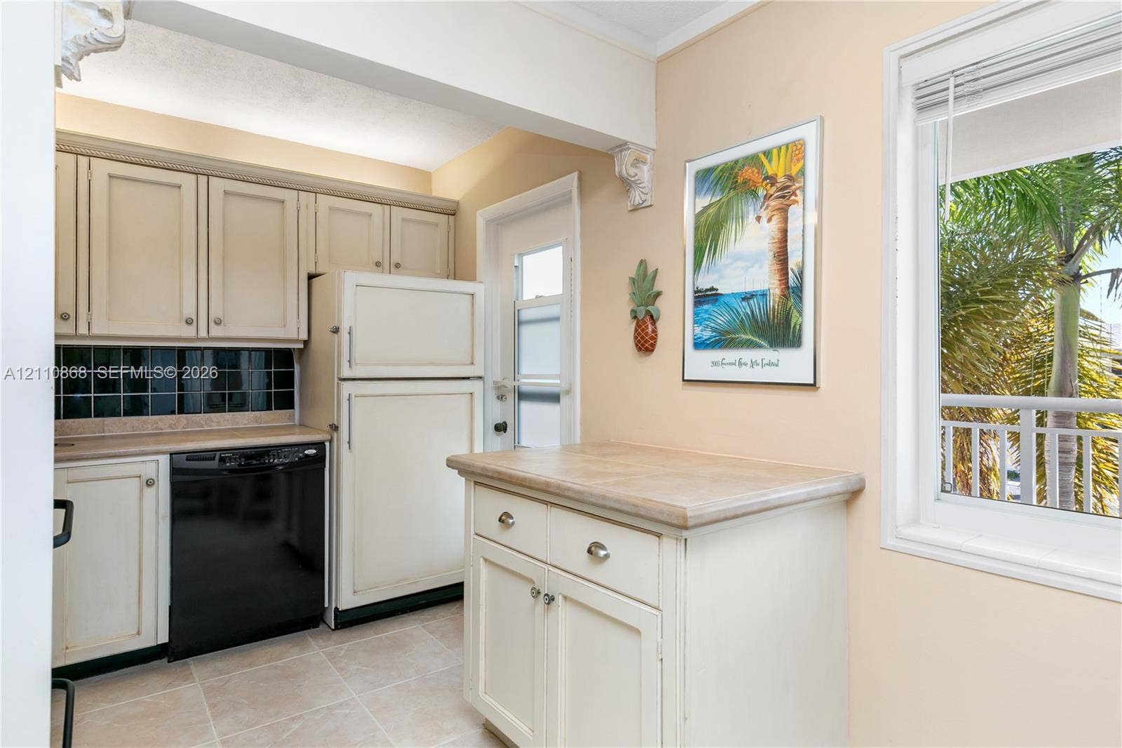 3121 S Ocean Drive, #209, Hallandale Beach, FL 33009 Kitchen featuring off-white cabinetry, black tile backsplash, solid-surface countertops, tile flooring, and a glass-paneled exterior door